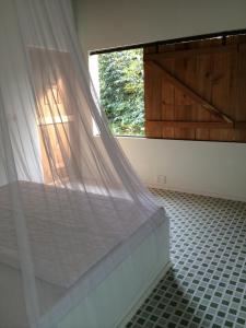 Tempat tidur dalam kamar di The Durian Lodge at Mekong