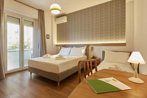 Postel nebo postele na pokoji v ubytování Hotel Tritone