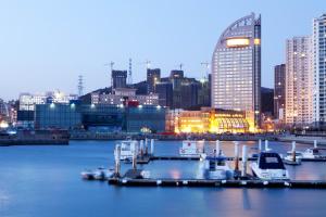 a view of a city with boats docked in the water at Bayshore Hotel Dalian in Dalian