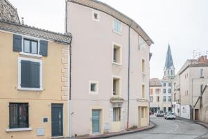 a white building on the side of a street at Le Cacao in Tain-lʼHermitage