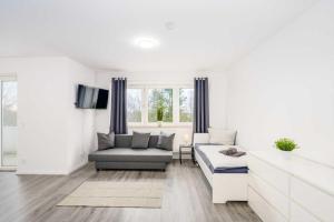a living room with a couch and a chair at Modern Apartments near Bottrop in Gladbeck