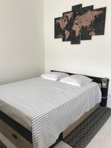 a bedroom with a bed and a map on the wall at Studio 35m2 à 3 km de la gare d Angoulême avec draps et linge de maison fournis in Le Gond-Pontouvre