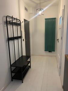 a room with a black chair and a green window at Apartament Warszawska 33 in Mrągowo +1 photo