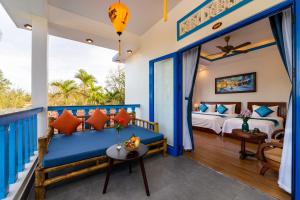 a bedroom in a villa with a bed and a balcony at LOCAL BEACH FRONT VILLAS in Tân Thành (1)