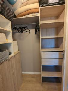 a closet with a bunk bed and shelves at Nina studio 5 Places avec vue sur la baie au pied des commerces Classé 3 étoiles in Pornichet