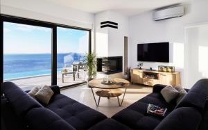 a living room with a couch and a table at Villa Infinity View in Primošten