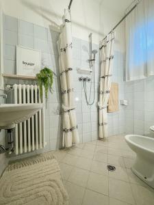 a white bathroom with a sink and a shower at Americana Beach House in Rimini