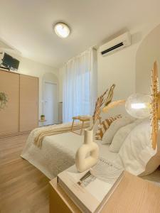 a bedroom with a bed and a table with a vase at Americana Beach House in Rimini