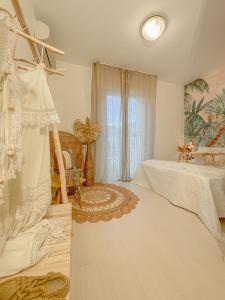 a bedroom with a bed and a window at Americana Beach House in Rimini