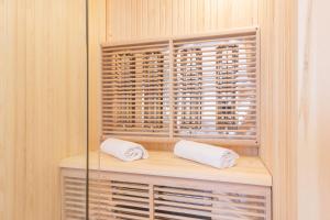 two towels sitting on a shelf in a closet at Minerva Guesthouse in Trento +77 photos