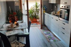 a kitchen with a glass table and a counter top at Ai piedi del Centro Storico in Castiglione del Lago