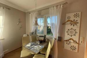 a dining room with a table and a window at Ferienwohnung OTTOSIN mit Terrasse und Garten in Dargen