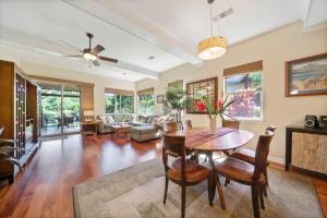 a living room with a table and chairs and a couch at Big Island Fairways at Mauna Lani 1705 townhouse in Waikoloa