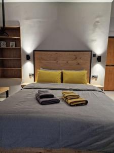 a bedroom with a bed with two towels on it at Vv Cosy Host 1 in Larisa