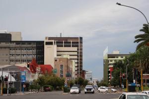 a busy city street with cars driving on a street at Favour's 2 Bedroom Apartment on 77 in Windhoek