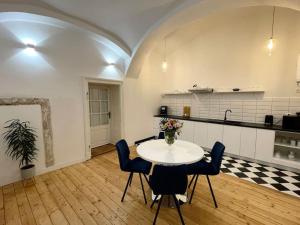 a kitchen with a table and chairs in a room at historical Zaffir house - market square in Levoča