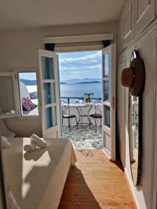 a room with a bed and a view of the ocean at Anemones Sea View in Mikonos