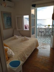 a bedroom with a bed with a view of the ocean at Anemones Sea View in Mikonos