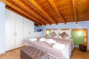 a bedroom with a bed with towels on it at Villa Olive Tree by Estia in Benitses