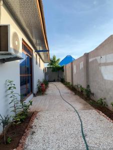 a driveway with a hose attached to a building at Nungwi holiday apartments in Nungwi