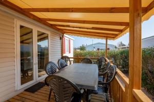 a wooden deck with a table and chairs at Mobil home Cécile in Fréjus