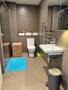 a bathroom with a toilet and a sink at Best location apartment in Olympic park in Sydney