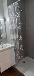 a shower with a glass door in a bathroom at Le Loriot in Saint-Nic