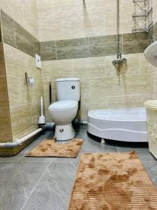 een badkamer met een toilet en een bad bij Comfort apartment in Tasjkent