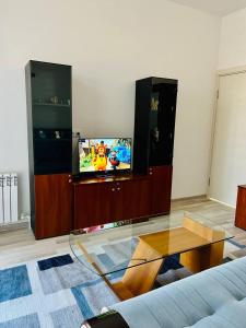 een woonkamer met een tv en een glazen tafel bij Comfort apartment in Tasjkent