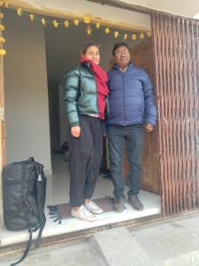 a man and a woman standing in front of a door at Budha ashram guest house in Bodh Gaya