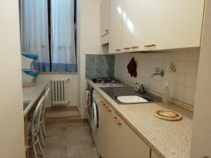 a small kitchen with a sink and a stove at Casa Marina in Orvieto