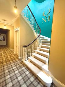 a hallway with stairs with an aquarium mural on the wall at Navidale House - Bed, Breakfast & Bar in Helmsdale