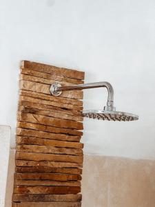 a light hanging on a wall next to a stack of wood at Met Beach Resort Malindi in Malindi