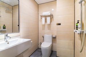 a bathroom with a toilet and a sink at Puzzle Hotel - Zhongshan 8th Road Chenjiaci Subway Station Branch in Guangzhou