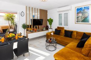 a living room with a couch and a table at Apartment Rose Pool Comfort in Dubrovnik