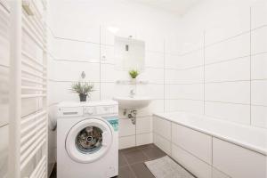 a white bathroom with a washing machine and a sink at Modern Apartment near Bottrop in Gladbeck