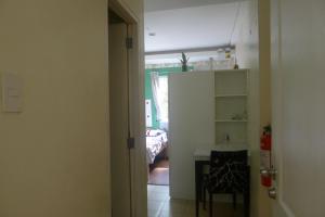 a room with a kitchen and a table in a room at Amabel's Condo Unit K 2LC in Baguio