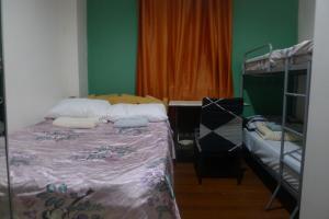 a bedroom with a bed and a bunk bed at Amabel's Condo Unit K 2LC in Baguio