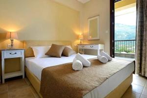 a hotel room with two beds and a balcony at Seascape Villas Kinira - Elia & Anatoli in Kinira