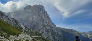 a person is looking up at a mountain at APPARTAMENTO CAMPO IMPERATORE in Castel del Monte