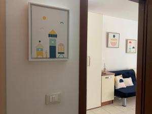 a hallway with a door with a picture on the wall at APPARTAMENTO CAMPO IMPERATORE in Castel del Monte