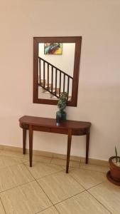 a wooden table with a mirror on a wall at Ocean View Apartment D7 in Mombasa