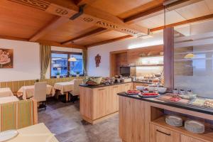 a restaurant with a counter with food on it at Gästehaus Emil in Sölden +29 photos