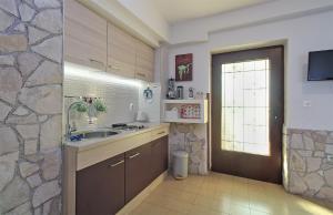 a kitchen with a sink and a window and a door at Apartment Leona 2216 in Premantura