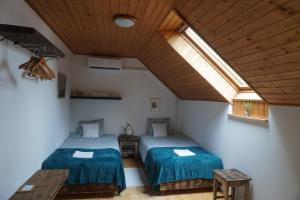 a room with two beds in a room with a window at Villa Grande Hévíz in Hévíz