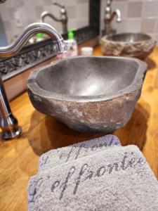 a stone sink in a bathroom with a towel at L'Effrontée in Tourrettes-sur-Loup