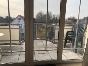 an open window with a view of a balcony at Hafenstr_22 Wohnung 7 in Zingst
