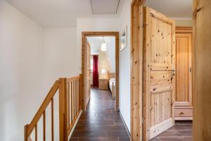 a hallway with a wooden door and a staircase at Dorfstr_ OT Mueggenburg in Klein Kirr