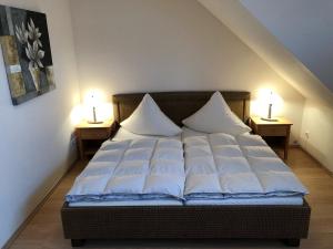a bed with two pillows on it in a room at Strandstr_ in Zingst
