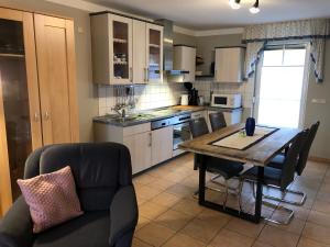 a kitchen with a table and chairs in a room at Seestr 75 a Haus A links in Zingst